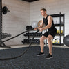 Rubber top exercise mat in black and blue, 0.79 inch thick, ideal for workouts in a gym setting.