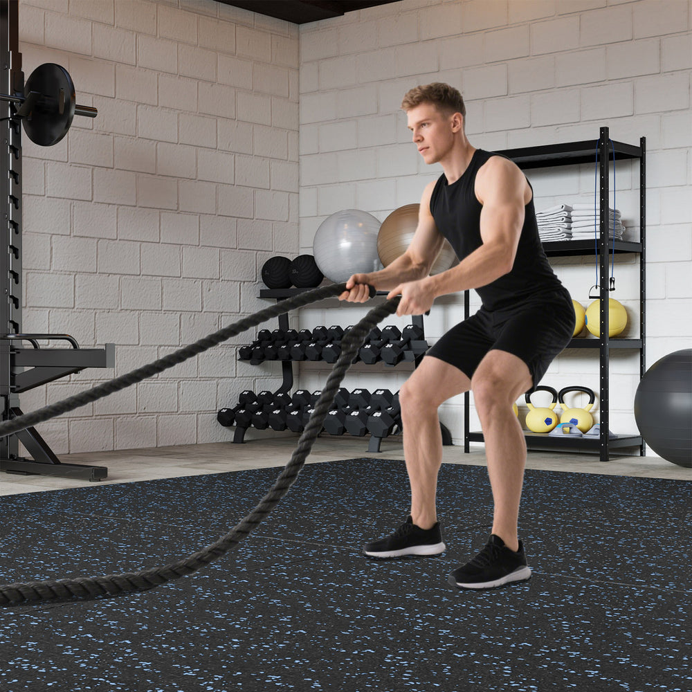 Rubber top exercise mat in black and blue, 0.79 inch thick, ideal for workouts in a gym setting.