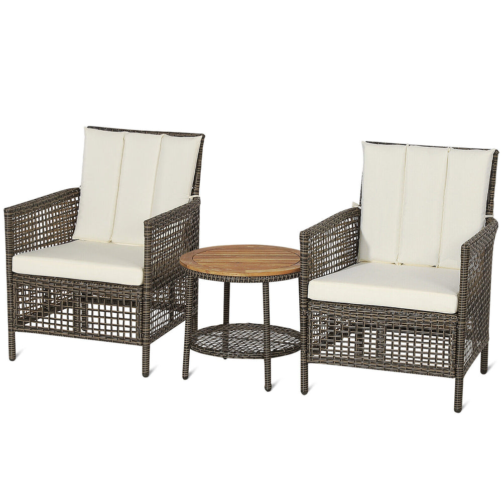 Two cushioned rattan chairs with a wood tabletop, perfect for outdoor relaxation in a patio setting.