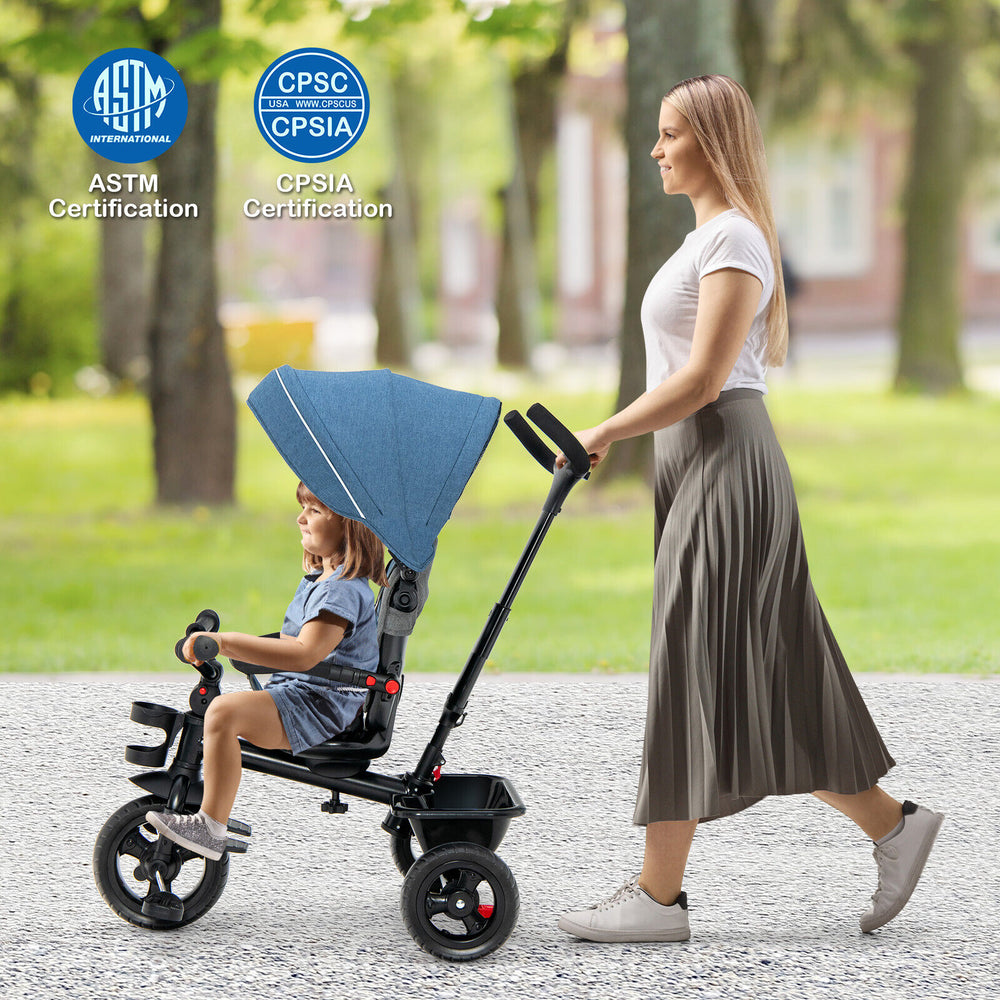 Child riding the blue 4-in-1 baby tricycle with adjustable canopy, showcasing its safety features and convertible seat.