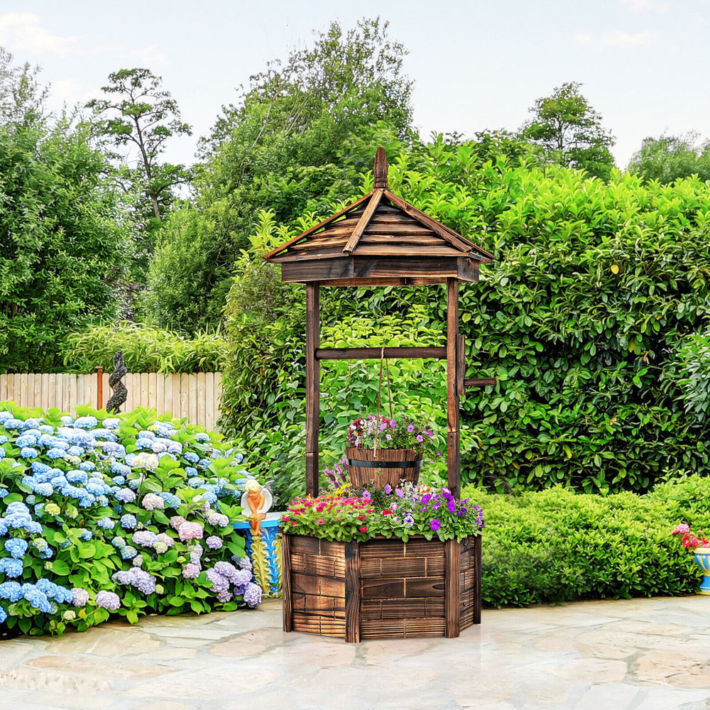 Rustic wooden wishing well with hexagonal roof and hanging bucket, perfect for growing plants in your garden or patio.