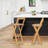 Set of 2 natural bamboo folding barstools with footrests, showcasing ergonomic design for comfort in a kitchen setting.