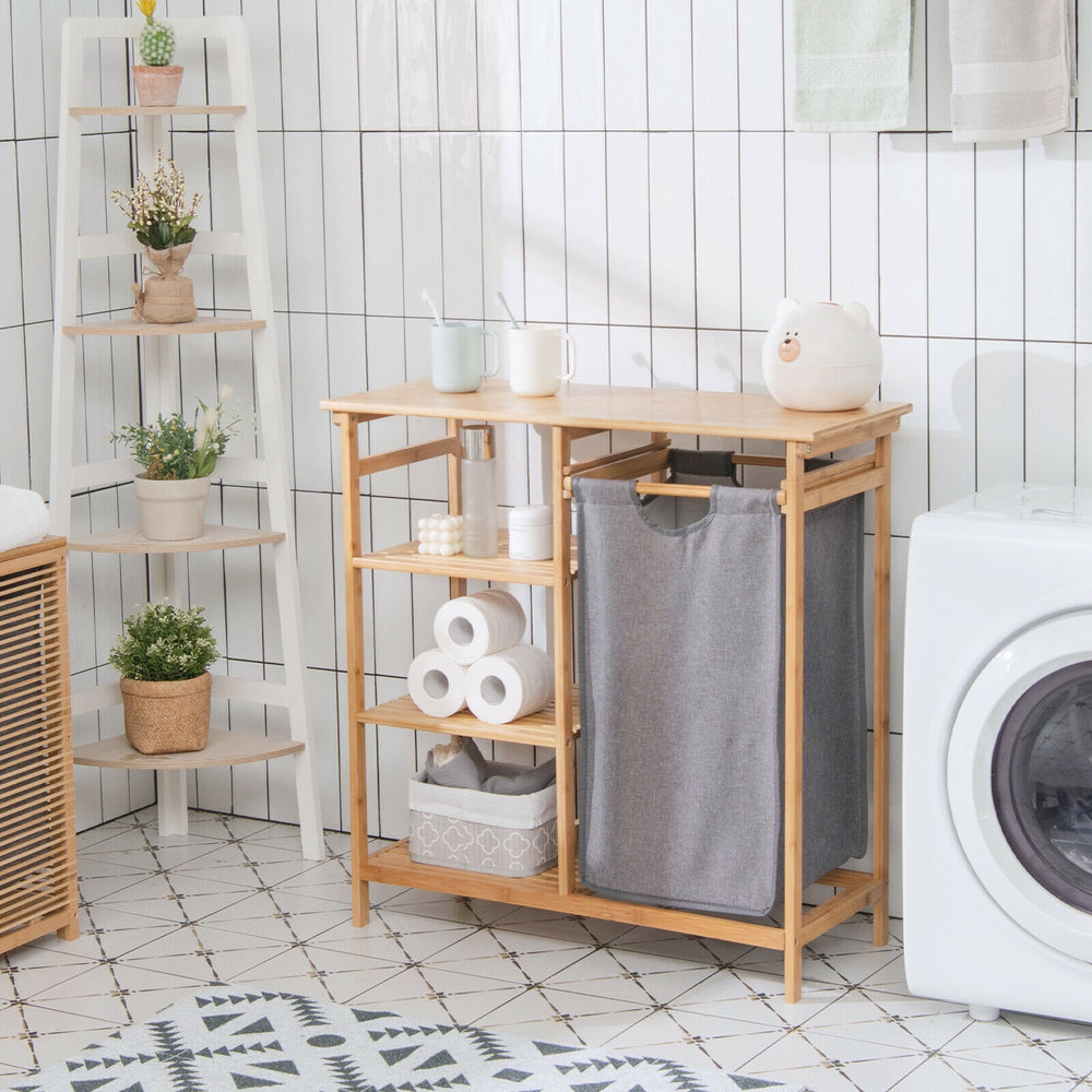 Bamboo laundry hamper stand with removable bag and 3-tier shelves for organized storage in bathroom or laundry area.
