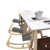 Ergonomic gray kneeling chair with curved base, designed for upright posture and comfort in office settings.