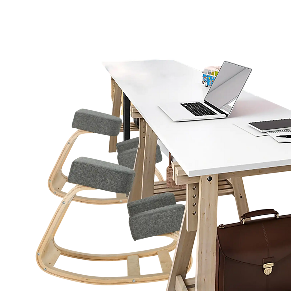 Ergonomic gray kneeling chair with curved base, designed for upright posture and comfort in office settings.
