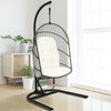 Hanging wicker egg chair with stand in beige, featuring a sturdy steel frame and comfortable cushions for indoor or.