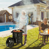 3-in-1 charcoal BBQ grill with built-in thermometer, shown in use outdoors, ideal for grilling and smoking meats.
