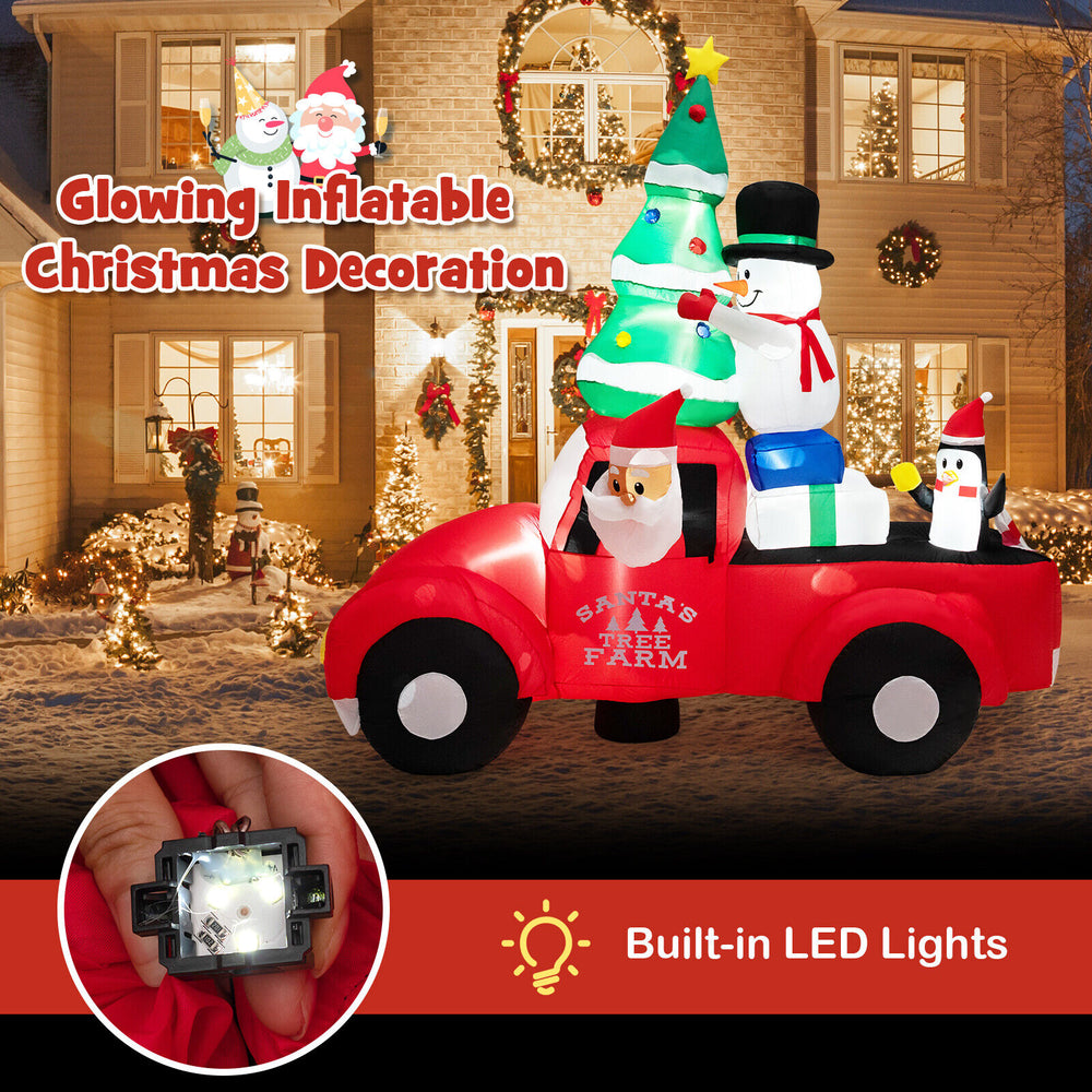 Inflatable Santa Claus driving a car with snowman and penguin, 8 feet wide, features built-in LED lights for Christmas.