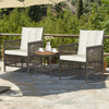 Two cushioned rattan armchairs with a wood tabletop, perfect for outdoor relaxation on a patio.