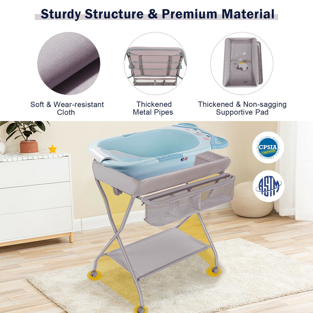 Baby changing table in gray with safety belt, storage basket, and foldable design for convenient use and baby care.