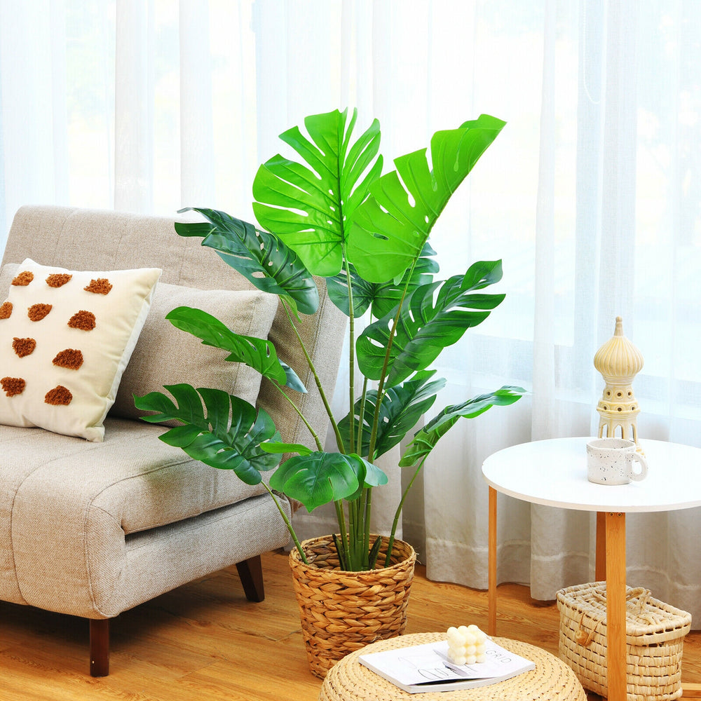 4 feet artificial Monstera Deliciosa tree with 10 vibrant leaves in a woven pot, perfect for indoor decoration.