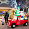 Inflatable Santa Claus driving a car with LED lights, snowman, and penguin, perfect for outdoor Christmas decorations.