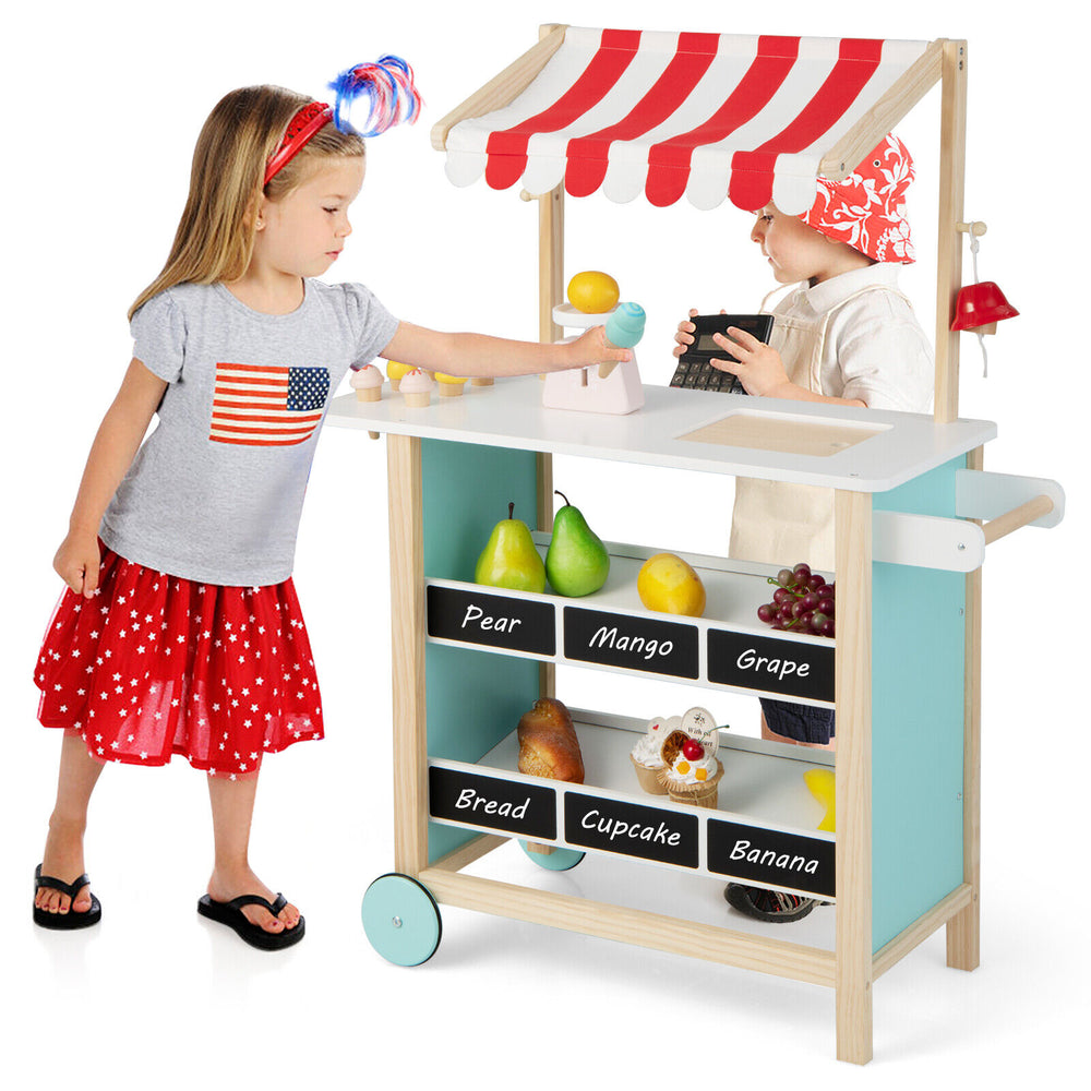 Kids wooden ice cream cart in red with chalkboard, featuring toy fruits and storage shelves for imaginative play.