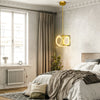 Modern LED pendant light in golden finish, adjustable suspender, ideal for stylish bedroom illumination.