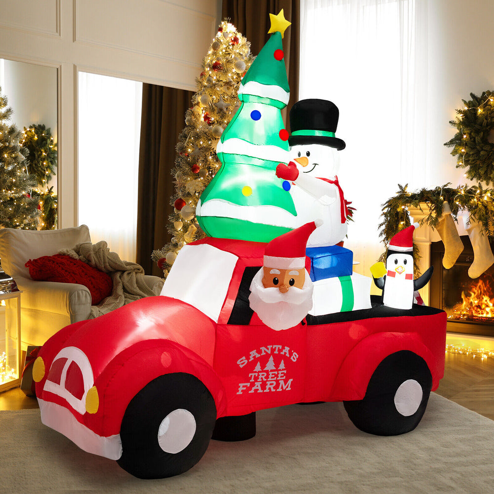 Inflatable Santa Claus driving a car with LED lights, snowman, and penguin, perfect for Christmas outdoor decoration.