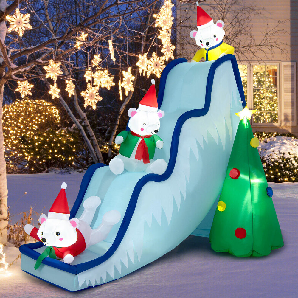 Inflatable 9 feet polar bear slide scene with Christmas tree and LED lights, perfect for festive outdoor holiday fun.