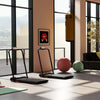 Folding treadmill and hanging punching bag set in a modern fitness room, ideal for home workouts and training.