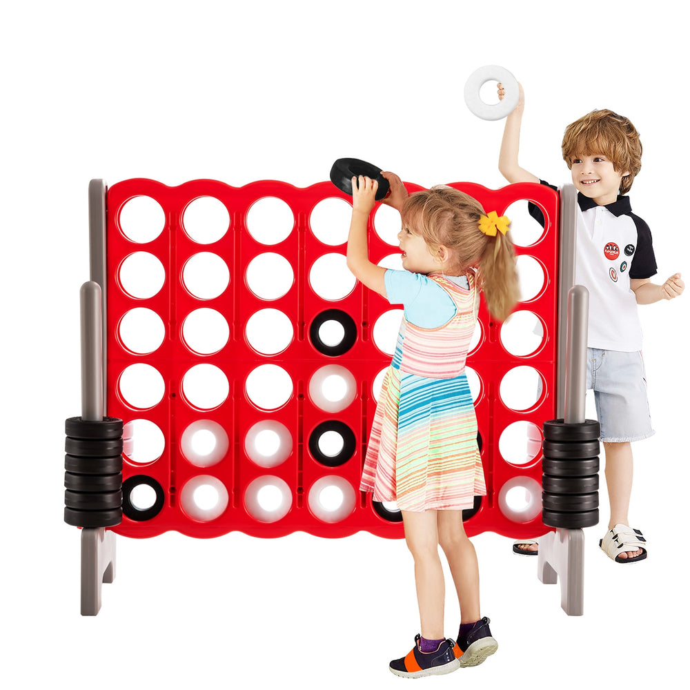 Children playing with the 3.5 feet tall Jumbo 4 to Score game set, featuring 42 jumbo rings in red for outdoor fun.