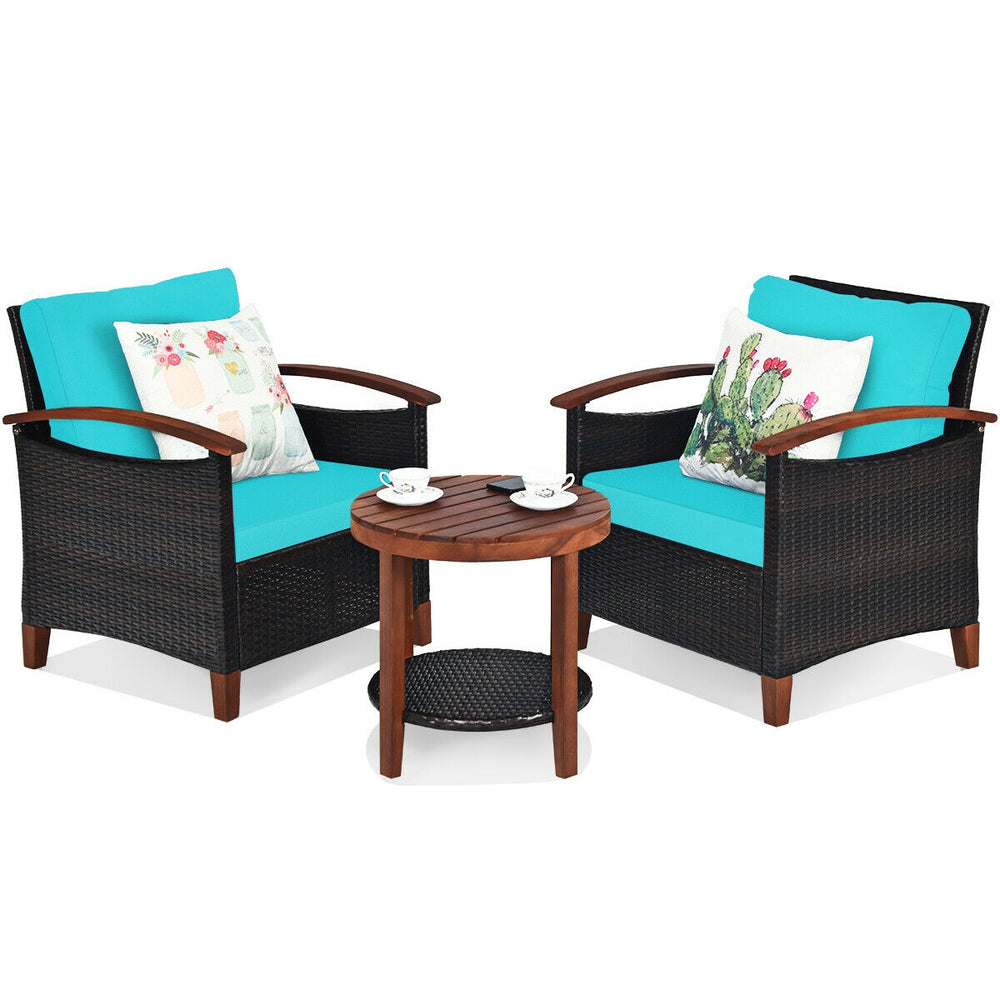 Two turquoise cushioned chairs with a wooden coffee table, perfect for outdoor relaxation in a patio setting.