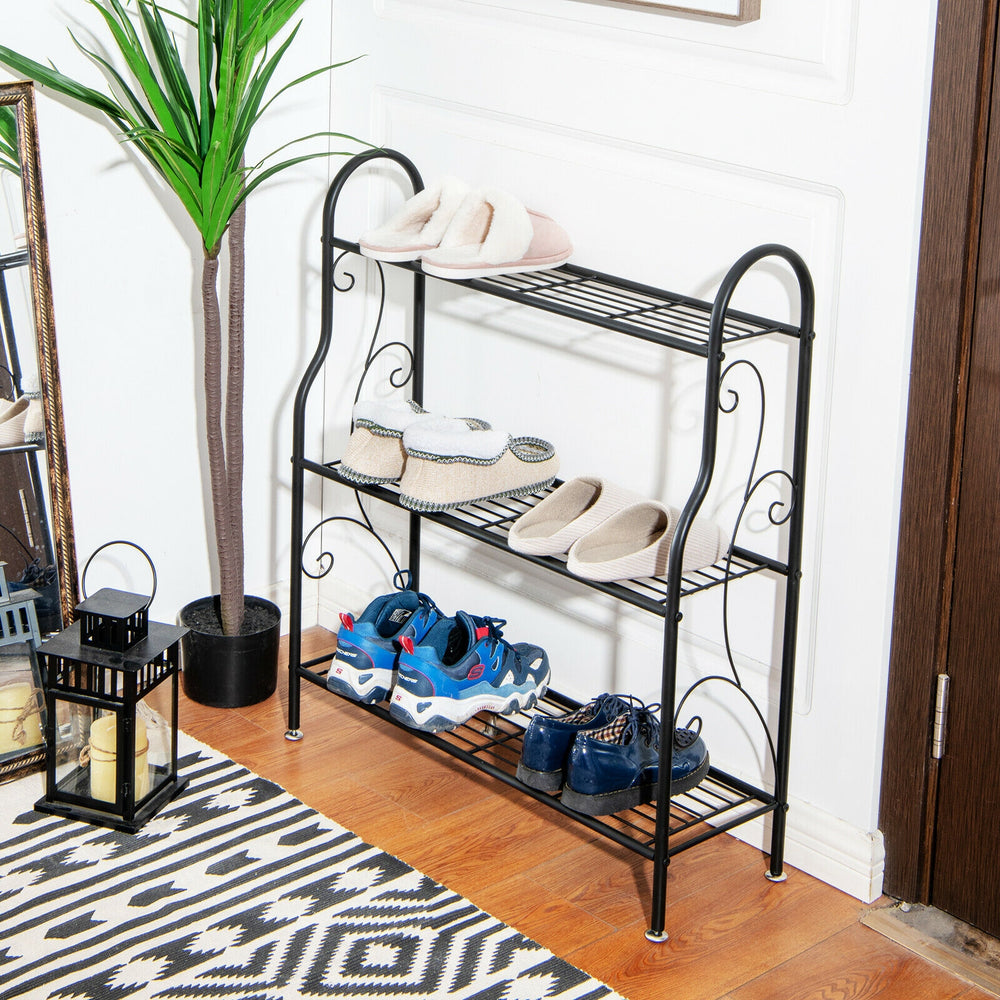 Three-tier black metal plant stand showcasing shoes, ideal for organizing plants and enhancing home decor.