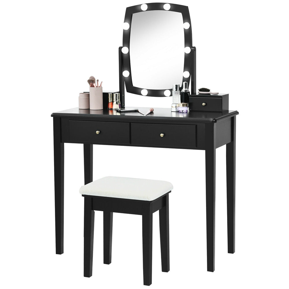 Black vanity table set with lighted mirror, featuring 10 dimmable bulbs and ample storage for cosmetics in a bedroom.