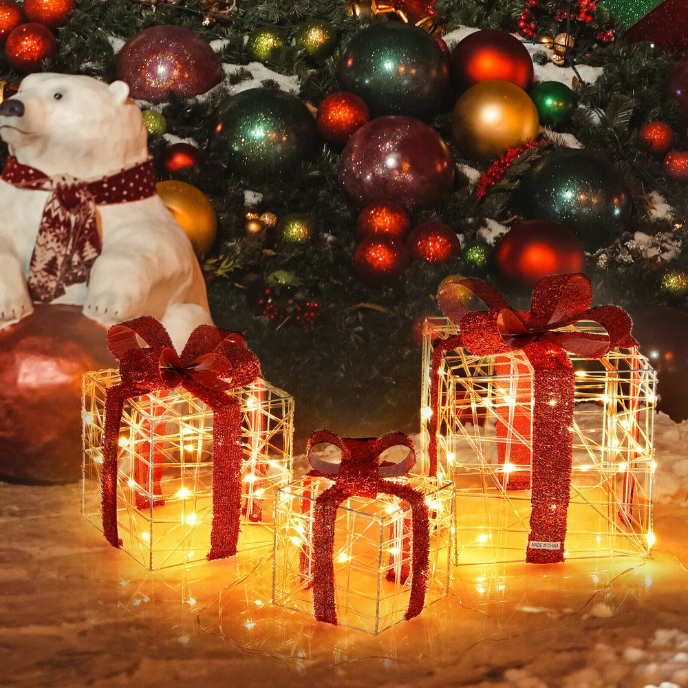 Lighted Christmas gift boxes in three sizes, adorned with red ribbons, creating a festive atmosphere with 60 LED lights.
