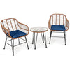 Patio rattan bistro set featuring two armchairs with navy cushions and a glass-top side table, perfect for outdoor.