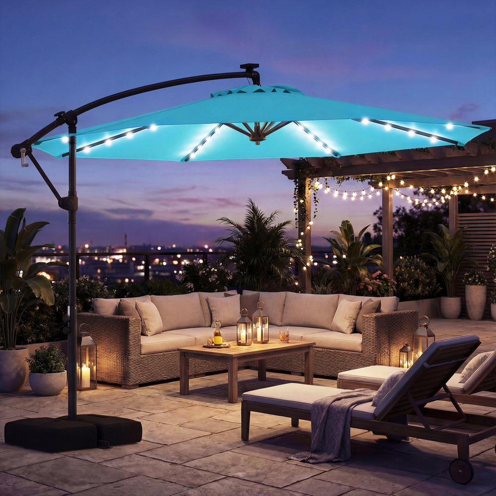 Turquoise 10 ft solar LED offset patio umbrella with 360° rotation, providing shade for outdoor gatherings.
