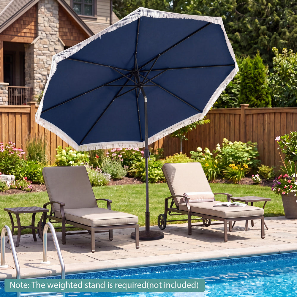 Navy 10 feet solar patio umbrella with tassels and LED lights, providing shade by the poolside for outdoor relaxation.