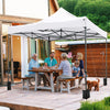 Outdoor pop-up canopy tent in white, 10 x 10 FT, providing shade for a family gathering on a patio.