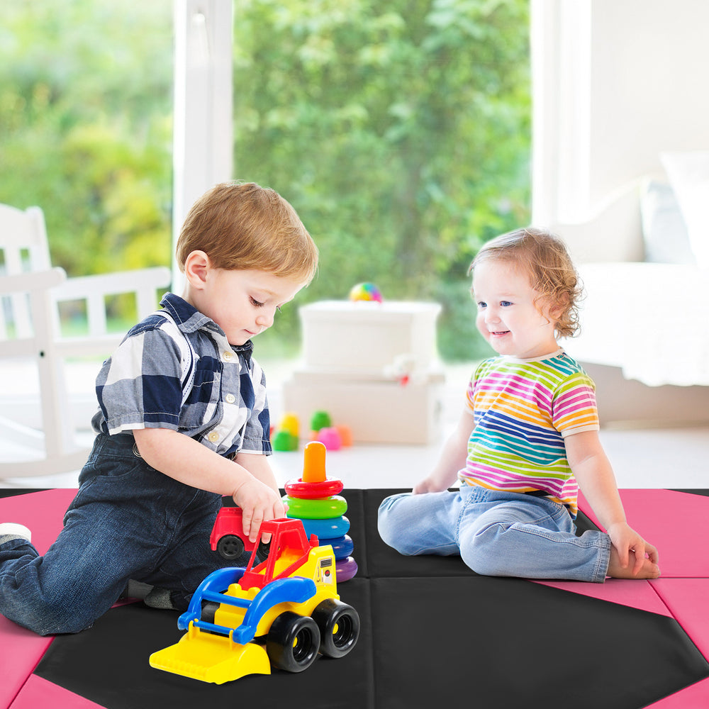 Children playing on a black and pink 10x4 folding exercise mat, ideal for home use and activities like gymnastics.