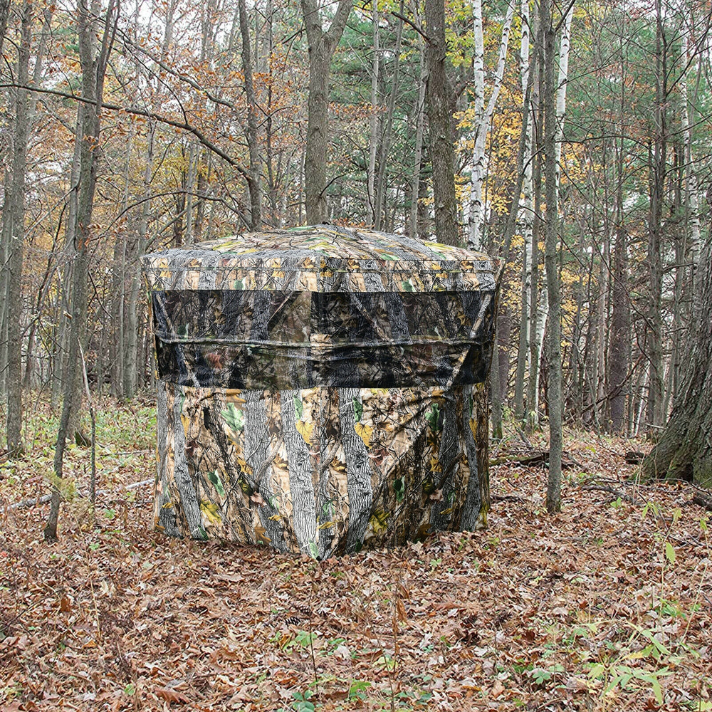 Portable 3-person tent with camouflage design, featuring multiple windows for enhanced visibility in the woods.