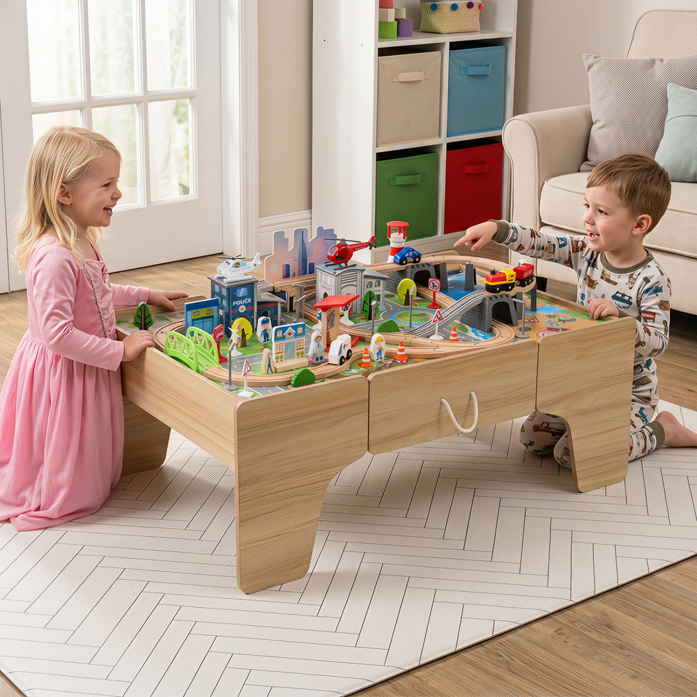 Children play with the 110-piece wooden train table featuring a colorful city layout, vehicles, and figures for imaginative fun.