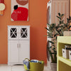Modern bathroom suite featuring a white floor cabinet with cross-patterned doors, ideal for storing towels and.