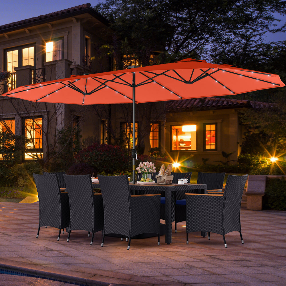 Patio dining set with LED umbrella, featuring navy cushions and hand-woven PE rattan, perfect for outdoor gatherings.