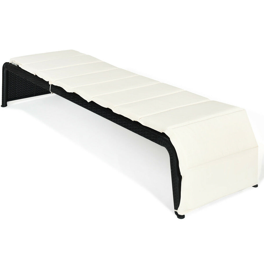 Adjustable patio rattan lounge chair with removable white cushion, perfect for outdoor relaxation by the pool or garden.