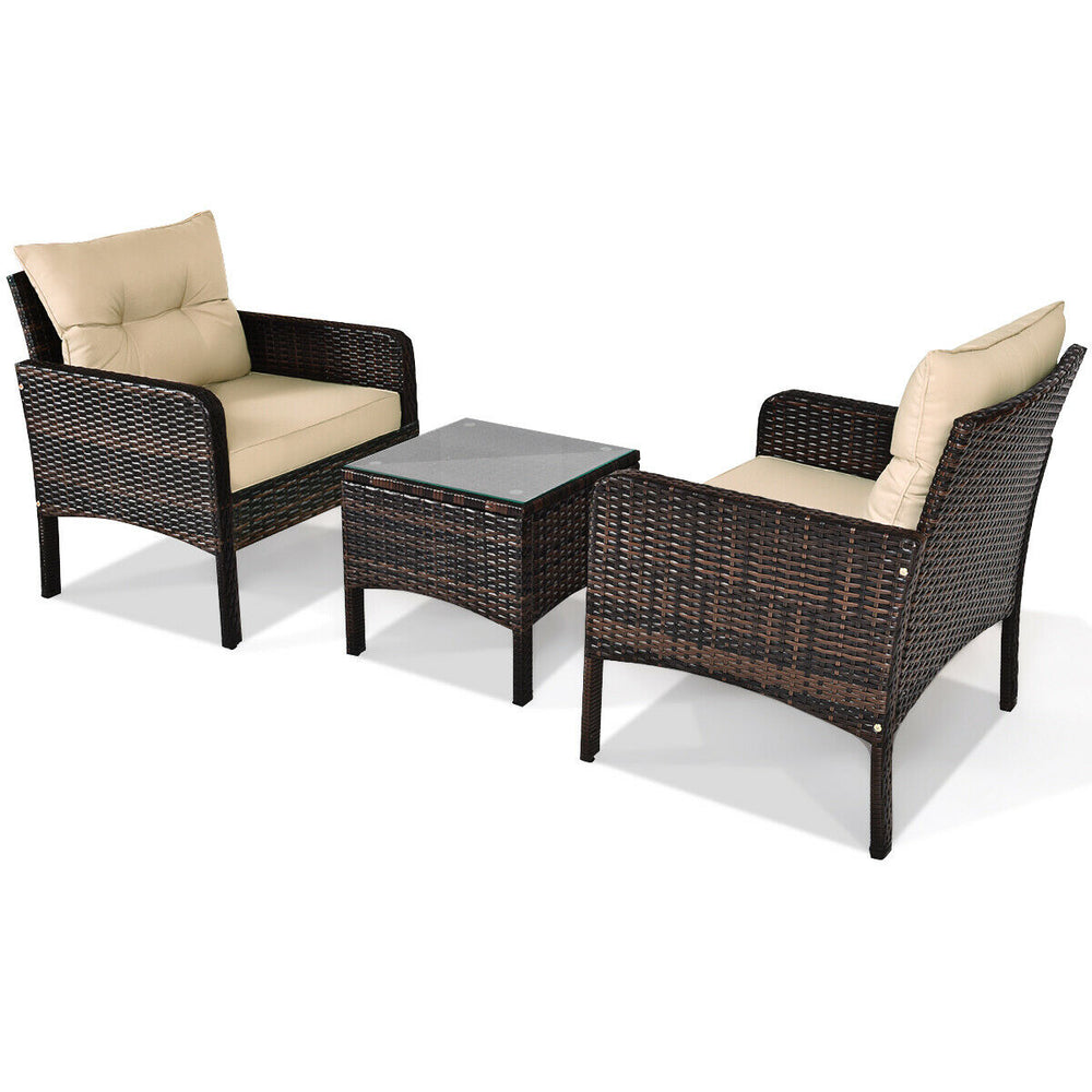 Outdoor patio rattan conversation set with beige cushions and tempered glass table, perfect for backyard relaxation.