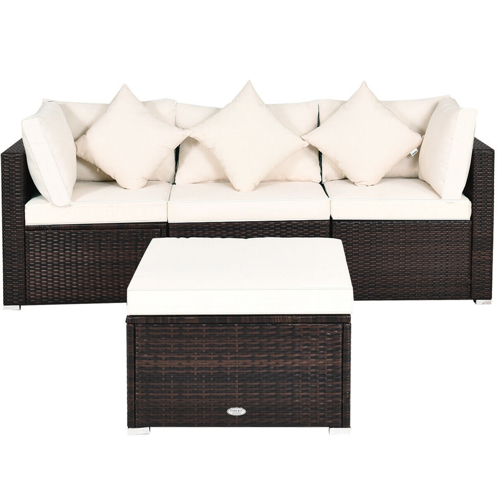 L-shaped 4-piece rattan wicker sofa set with white cushions, perfect for outdoor patios and gardens.