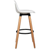 White mid-century barstool with beech wood legs and metal footrest, ideal for dining rooms or home bars.