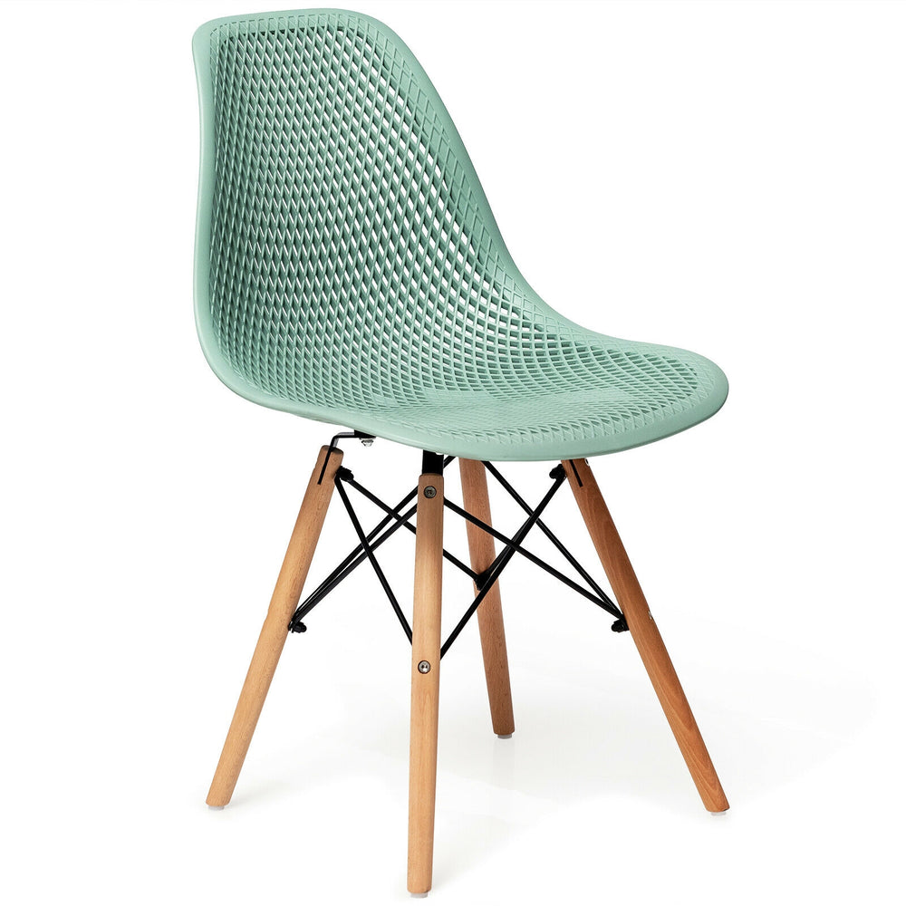 Modern green plastic hollow chair with beech wood legs, ergonomic design for dining or office use.