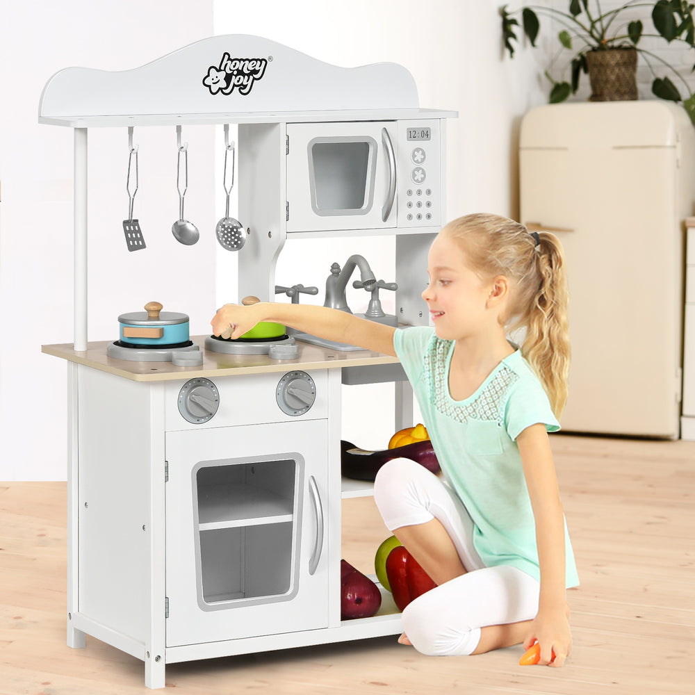 Wooden pretend play kitchen set for kids featuring a sink, stove, and oven, promoting imaginative role-playing and.