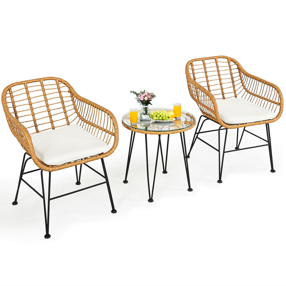 Round coffee table with a tempered glass top and stylish rattan design, ideal for serving drinks in outdoor settings.
