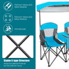 Portable folding camping canopy chair in blue with a cup holder and adjustable canopy for outdoor relaxation.