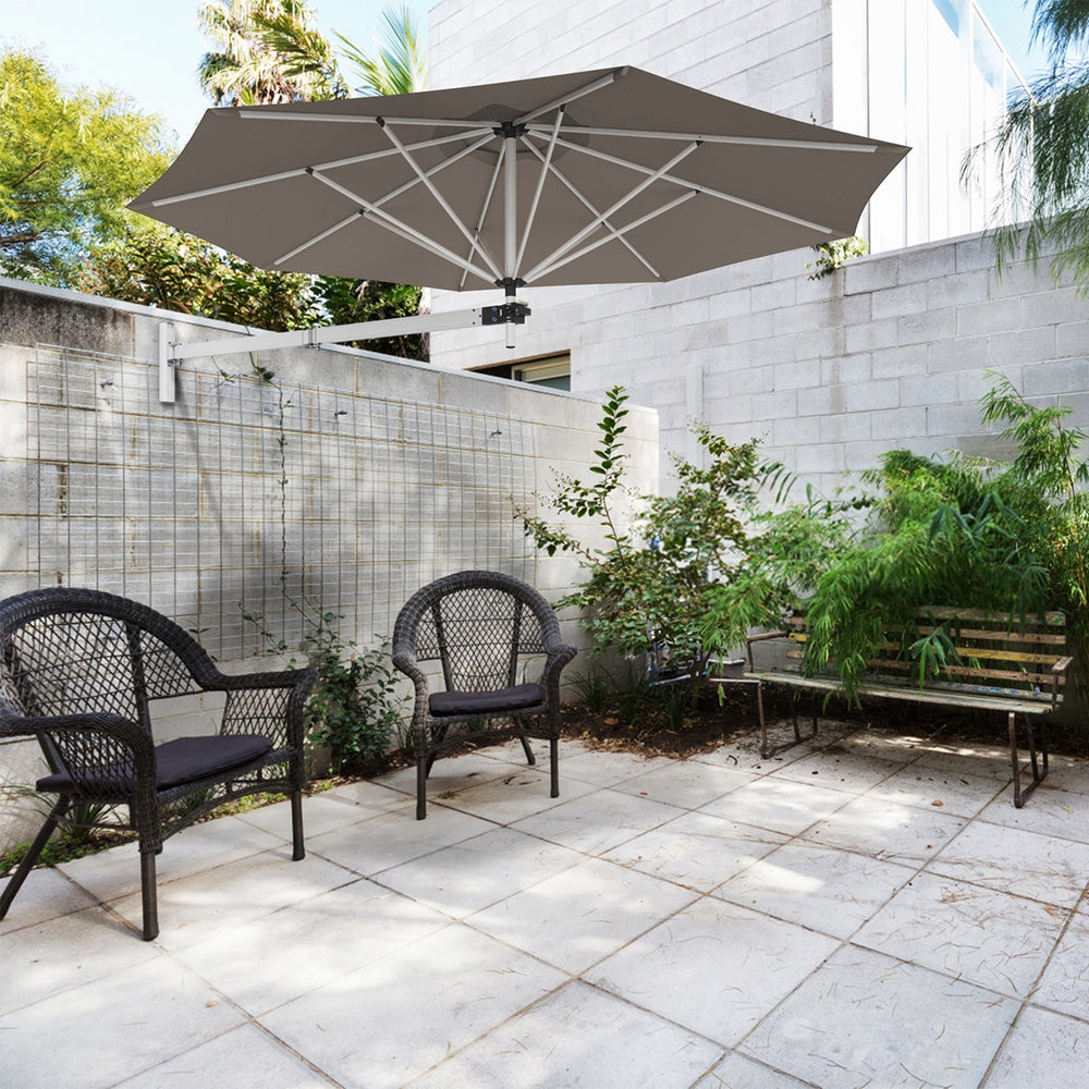 Wall-mounted 8ft tan sun shade umbrella with adjustable angle and heavy-duty aluminum frame for outdoor patio use.