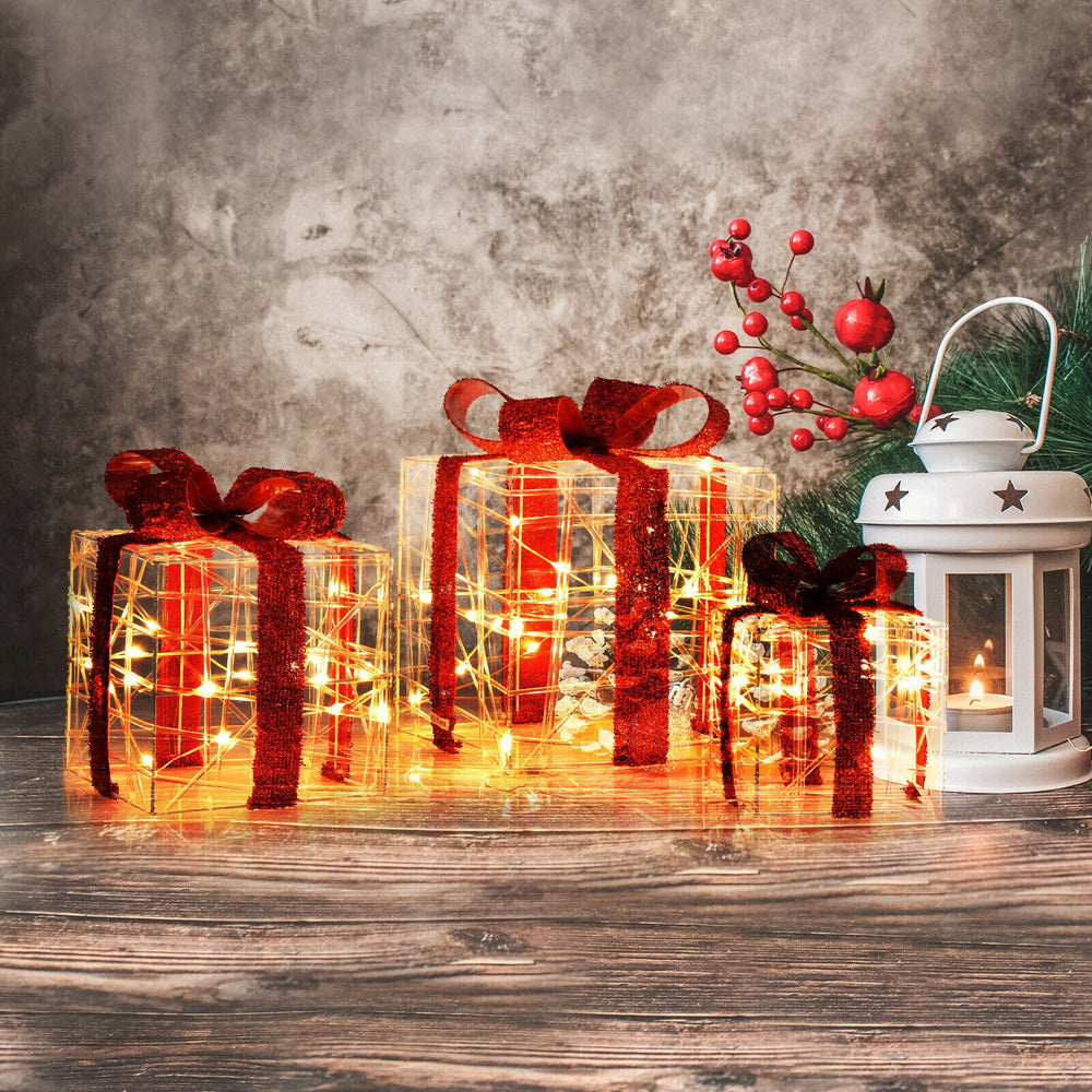 Three illuminated Christmas gift boxes with red ribbons, featuring 60 LED lights for festive indoor and outdoor.