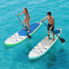 Two paddlers on 11 feet inflatable stand up paddle boards in turquoise water, showcasing stability and control features.