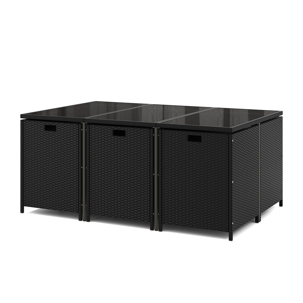 Black wicker dining table with tempered glass top, featuring a space-saving design for outdoor patio use.