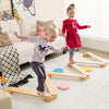 Kids balancing on a 12-piece wooden balance beam set with colorful stepping stones for imaginative play and motor skill.