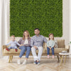 Artificial hedge boxwood panels in a living room setting, ideal for creating privacy screens or green wall backdrops.