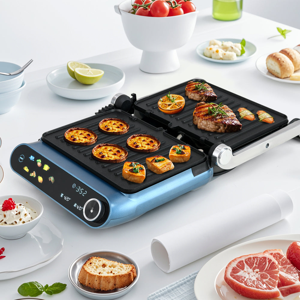 1200W blue panini press grill with LED display, showcasing grilled steak and vegetables, perfect for versatile cooking.